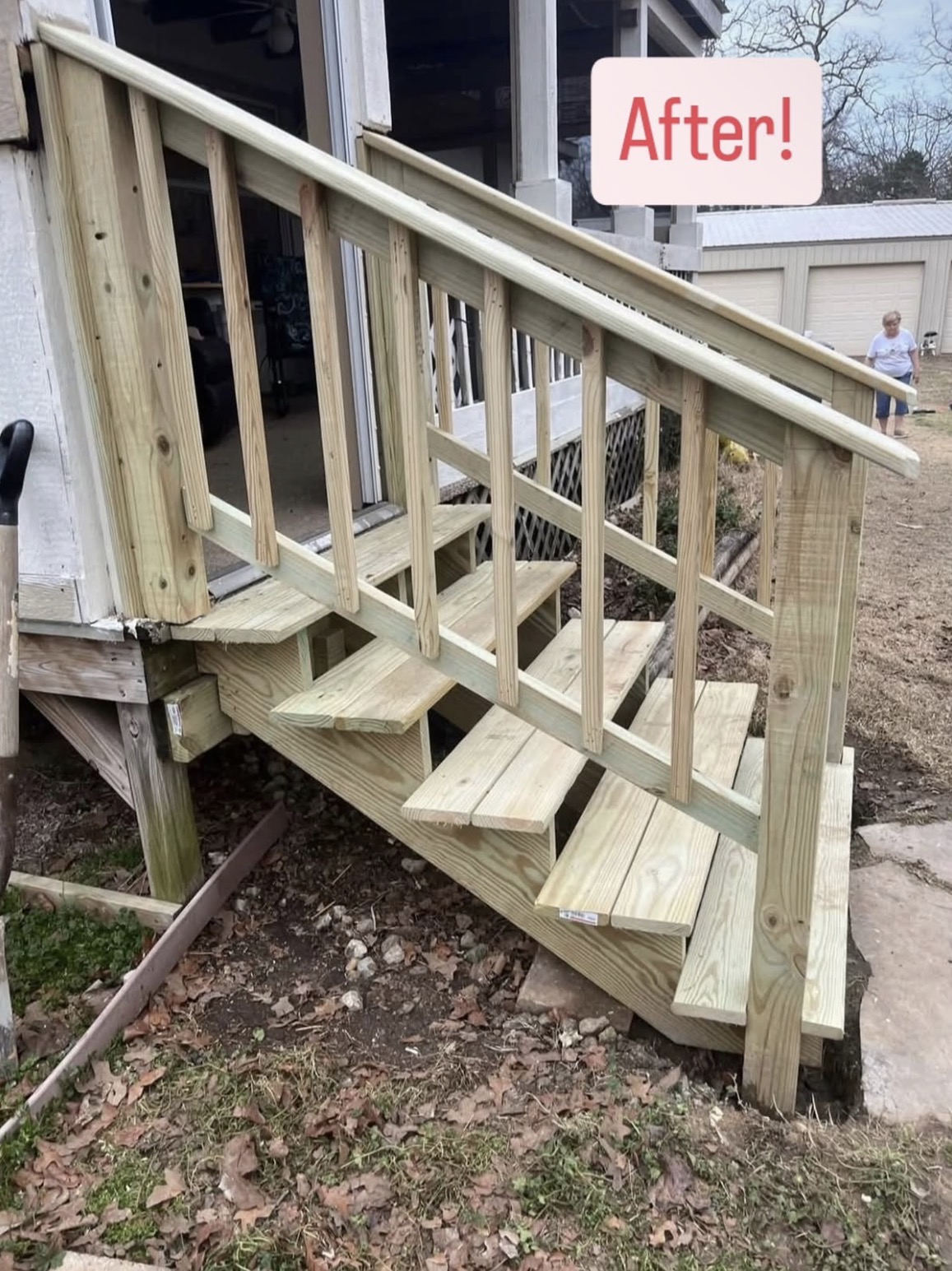 Newly rebuilt wooden deck stairs and railing