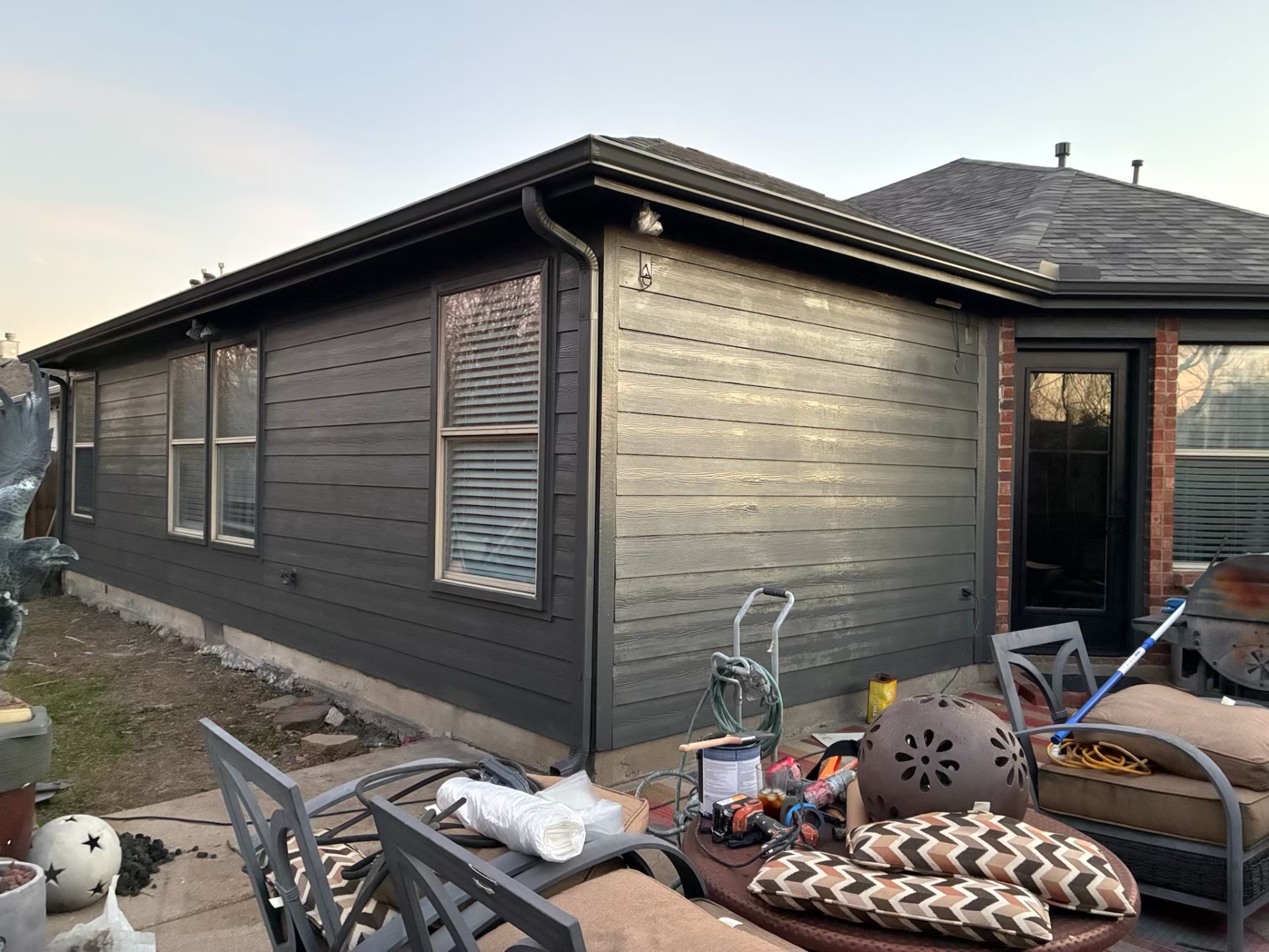Home exterior after full repaint in modern dark gray