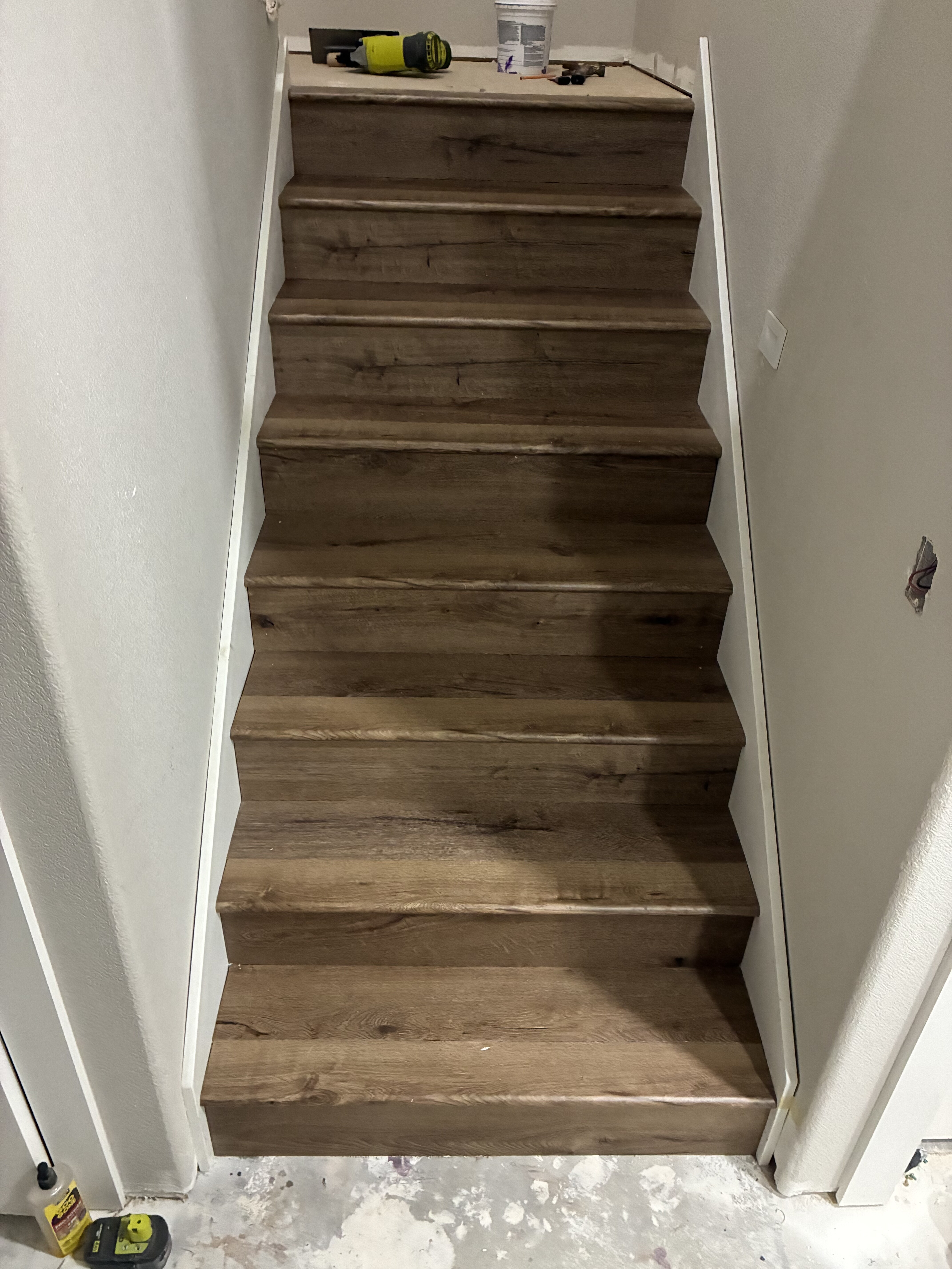 Staircase rebuilt with rustic wood-look vinyl plank treads and risers